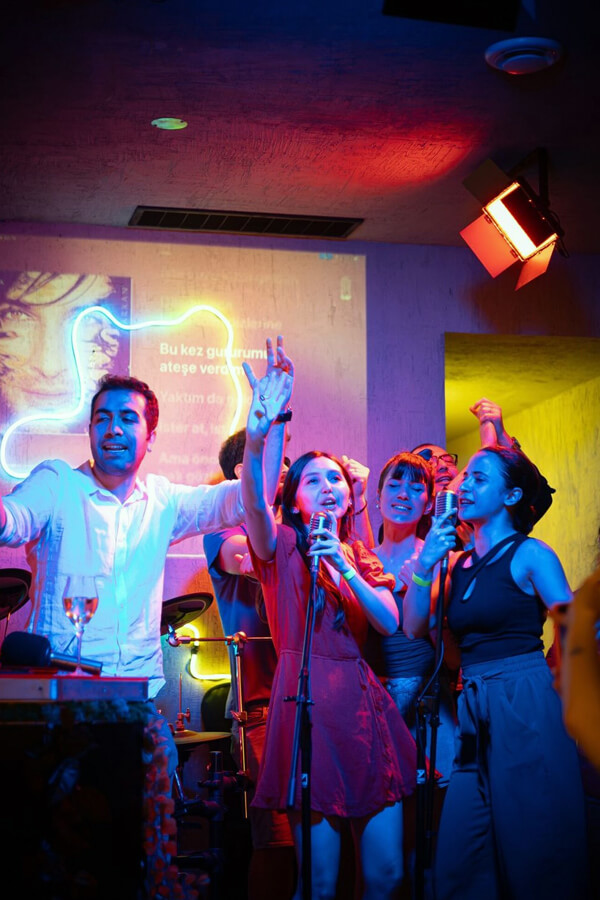 Karaoke night at Teddy Beer bar in Toronto with a group of friends singing on stage