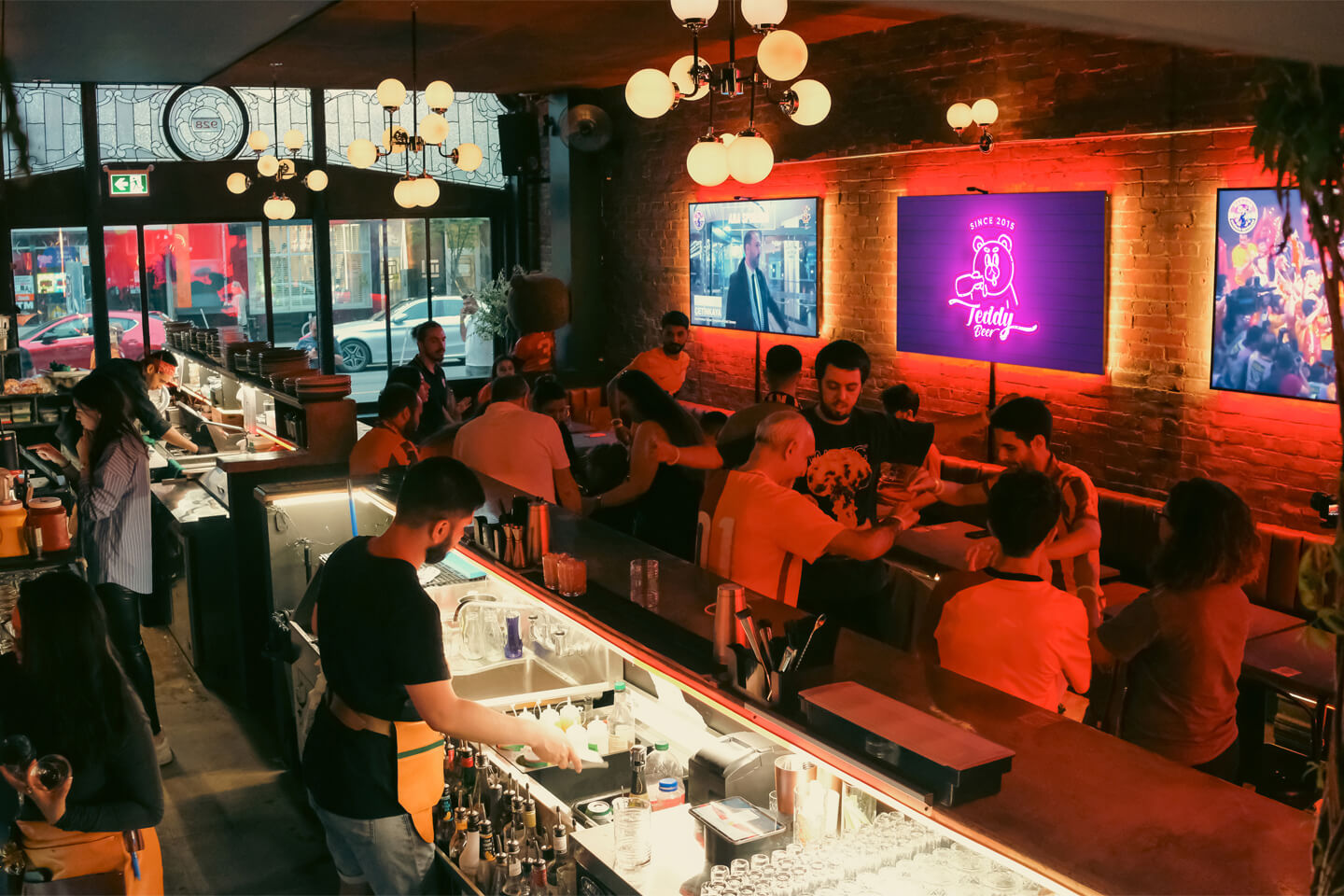 Inside view of Teddy Beer bar in Toronto, showcasing the vibrant atmosphere and bar setup