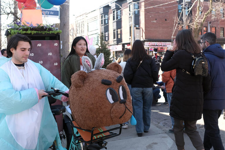 Teddy Bear mascot at Easter 2024 event with participants enjoying the festive atmosphere in the city.